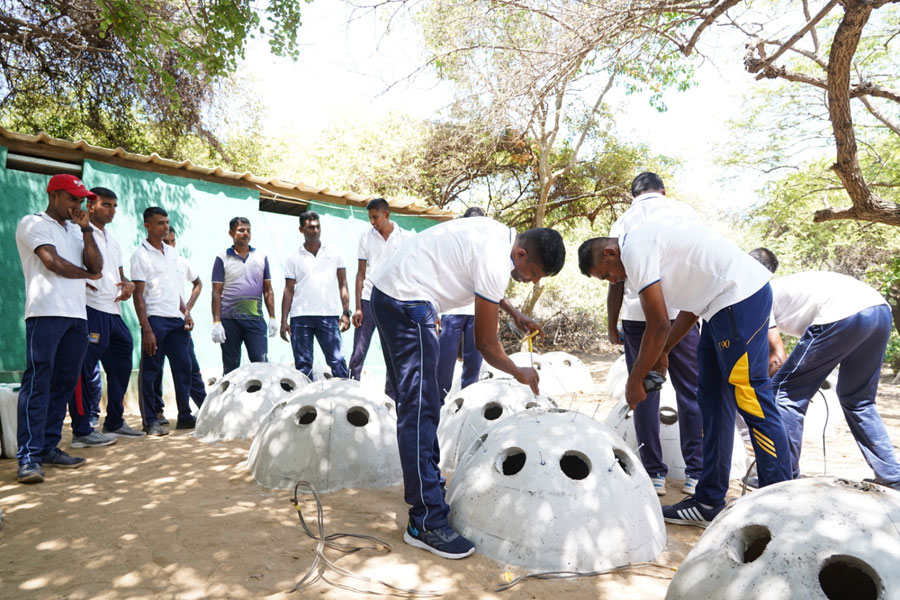 Preparing concrete reef balls for the coral restoration project at Marble Beach